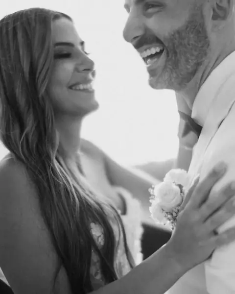 A couple laughing together on their wedding day