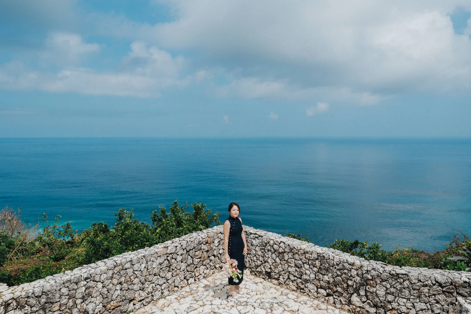 A couple at the altar on the cliff edge at Alila Villas Uluwatu