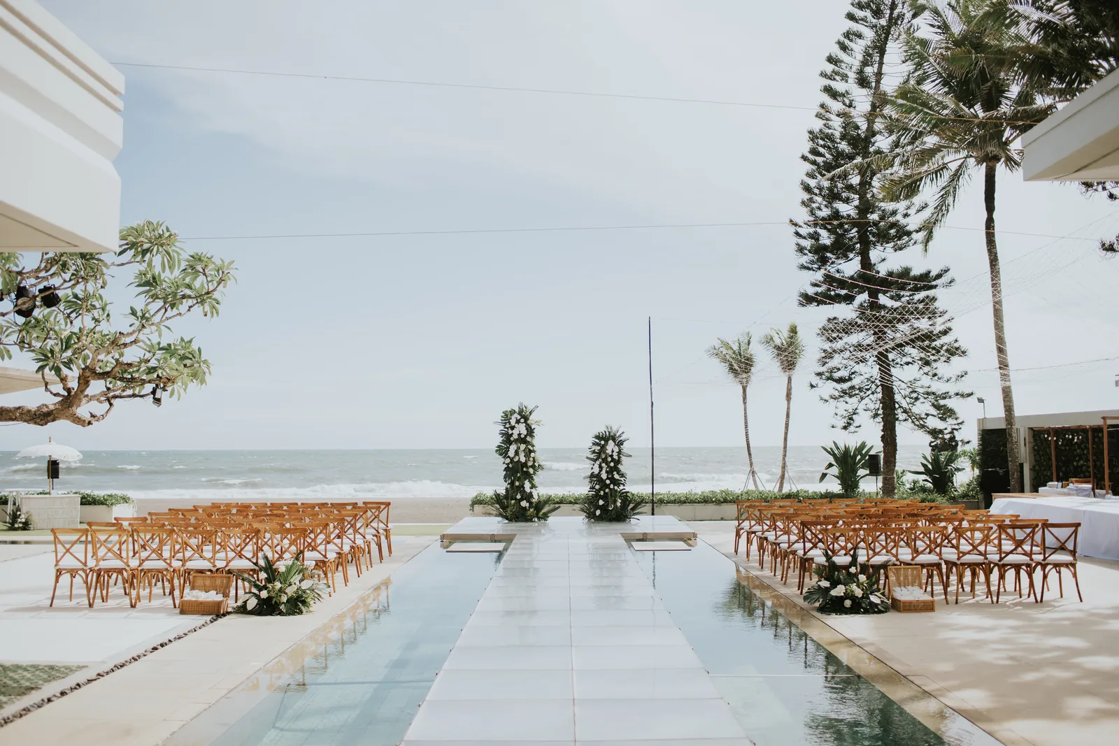 The ceremony aisle at Villa Vedas set across the water towards the beachfront, chairs either side